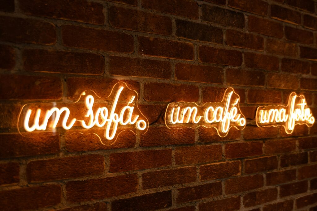 Neon lights on a rustic brick wall create a cozy café atmosphere.